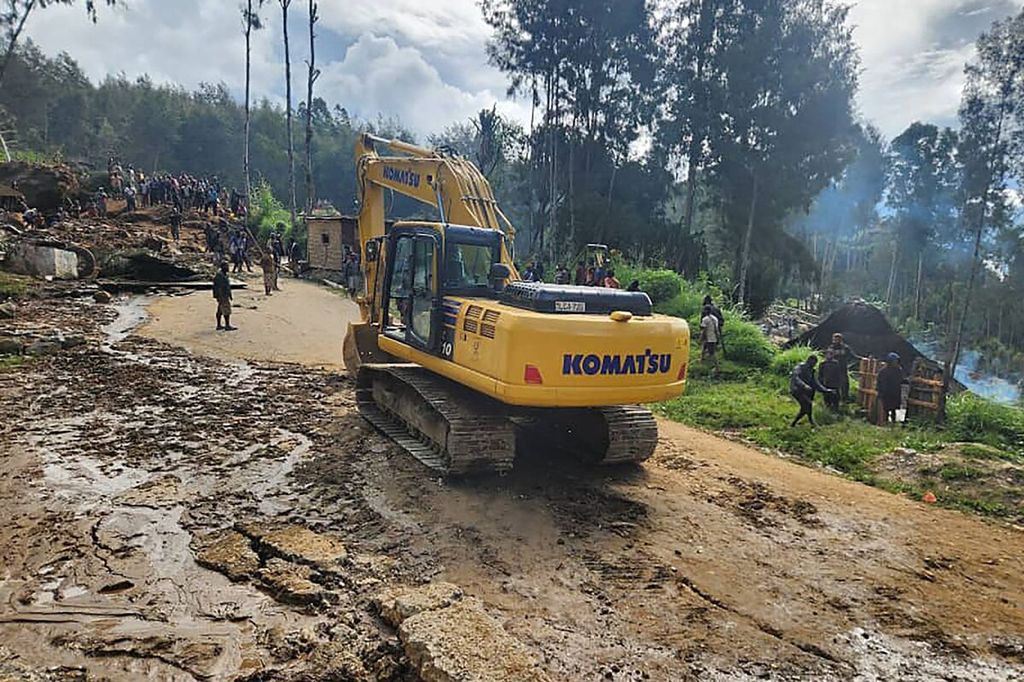 An excavator heads towards the landslide area in Yambali Village, Enga Province, Papua New Guinea, on May 26, 2024. More than 670 people died as a result of the disaster.