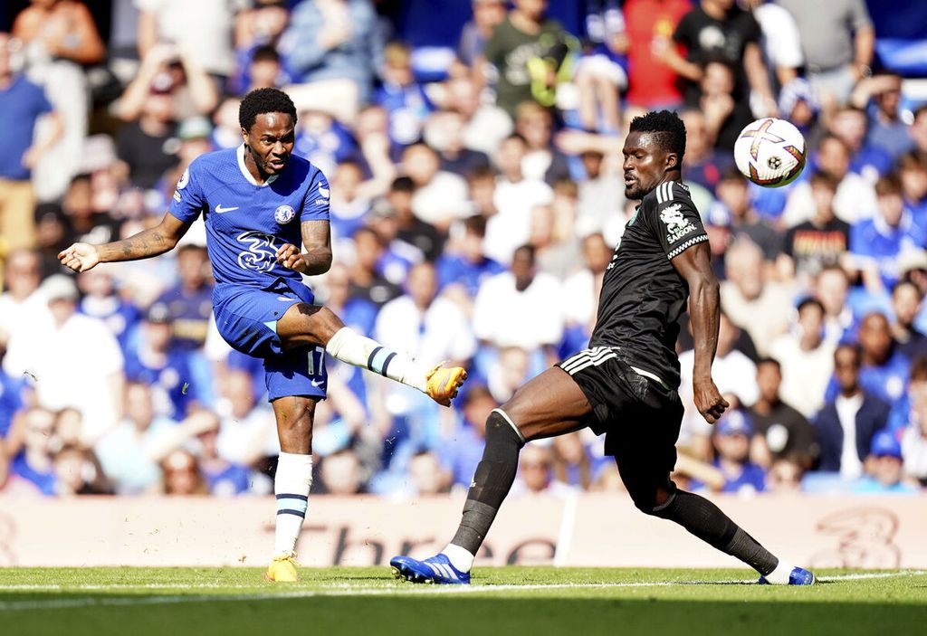 Penyerang Chelsea, Raheem Sterling (kiri), menembak bola yang berujung gol ke gawang Leicester City pada laga Liga Inggris di Stadion Stamford Bridge, London, Inggris, Sabtu (27/8/2022) malam. Chelsea menang, 2-1.