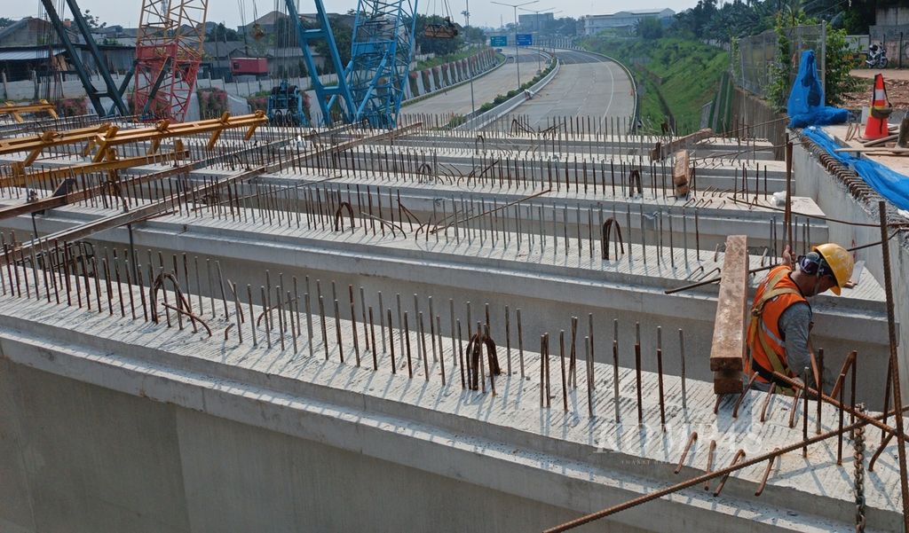 Pekerja konstruksi menyelesaikan pelebaran jembatan di atas Tol Cinere-Serpong seksi II di kawasan Pondok Cabe, Tangerang Selatan, Banten, Jumat (2/6/2023). Masifnya pembangunan infrastruktur dan properti di kawasan Jabodetabek menjadi magnet warga desa menjadi pekerja konstruksi di berbagai proyek infrastruktur ataupun properti.