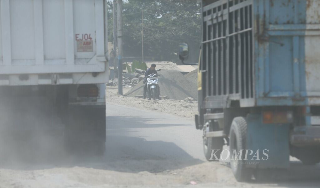 Polusi debu menjadi pemandangan sehari-hari di Jalan Raya Sukamulya, Rumpin, Bogor, Jawa Barat, Kamis (18/7/2019). 