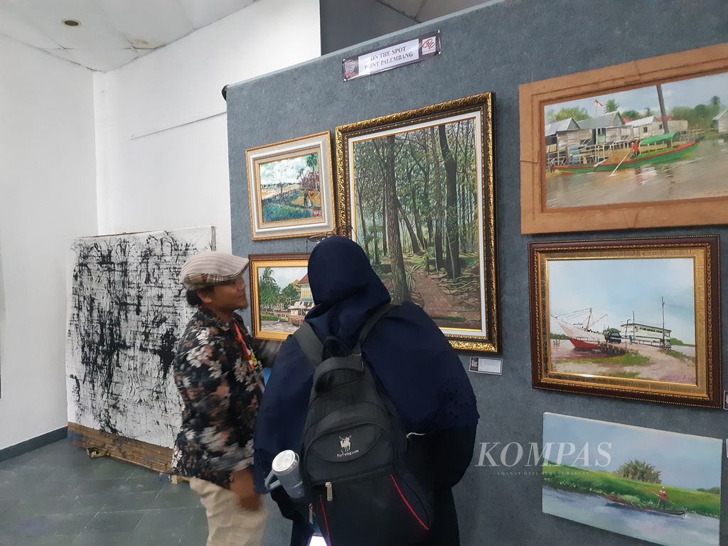 Beberapa pengunjung sedang melihat karya seni di sebuah pameran karya seni bertajuk ”Ekspresi Musi” di Taman Budaya, Jakabaring, Palembang, Sumatera Selatan, Selasa (30/5/2023). Ada 148 karya seni dari 48 seniman yang tergabung dalam 12 komunitas di Sumsel. 