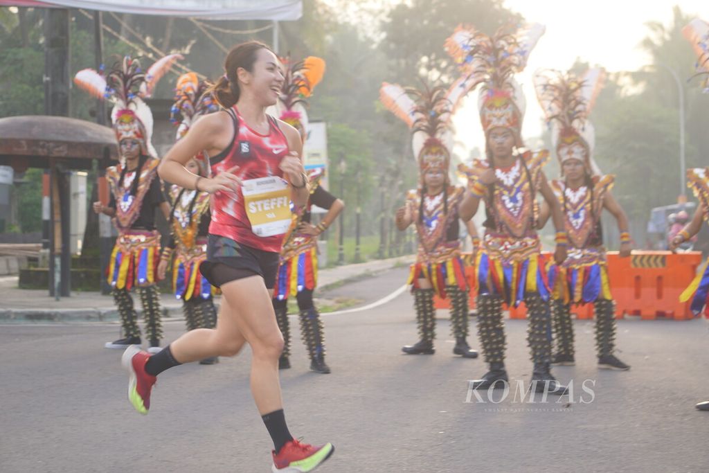 Steffi Audynia, pelari putri Elite Race, dihibur oleh Kelompok Cahyo Mudho Brayat Simbah Jogo saat ajang Borobudur Marathon 2022 Powered by Bank Jateng di Kawasan Candi Borobudur, Magelang, Jawa Tengah, Sabtu (12/11/2022).