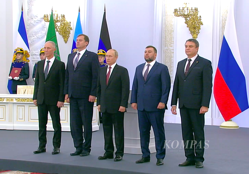 Dalam tangkapan layar dari siaran langsung Russia Today pada Jumat (30/9/2022) ini, Presiden Rusia Vladimir Putin (tengah) bersama pemimpin empat wilayah Ukraina meresmikan pencaplokan empat wilayah itu oleh Rusia. 