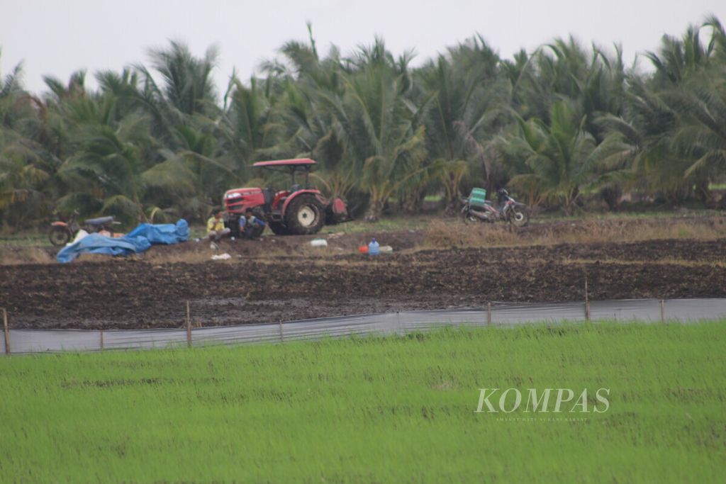 Aktivitas menggarap lahan sawah di Kecamatan Muara Sugihan, Kabupaten Banyuasin, Sumatera Selatan, Selasa (7/12/2021). Sebagai provinsi penghasil beras, Sumsel masih dilanda data lahan baku sawah yang timpang.