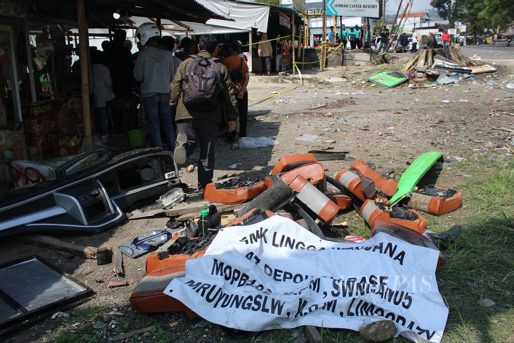 Warga melintasi tumpukan interior bus yang terlibat kecelakaan di Jalan Raya Ciater, Kabupaten Subang, Jawa Barat, Minggu (12/5/2024). 