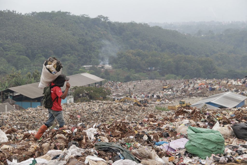 Seorang pemulung mengangkut sampah di Tempat Pembuangan Akhir Sampah Sarimukti, Kabupaten Bandung Barat, Jawa Barat, Sabtu (19/2/2022).