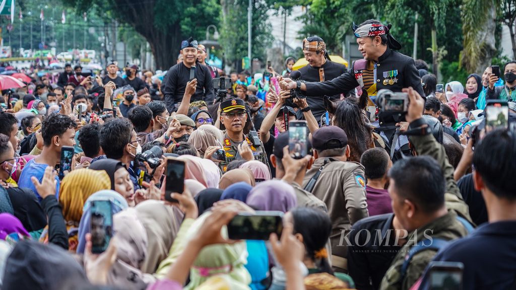 Bogor Mayor Bima Arya Sugiarto (right) and Deputy Mayor Dedie A Rachim (second from the right) greet residents during the Bogor City's 540th Anniversary Parade on Kapten Muslihat Street, Bogor City, on Friday (3/6/2022).
