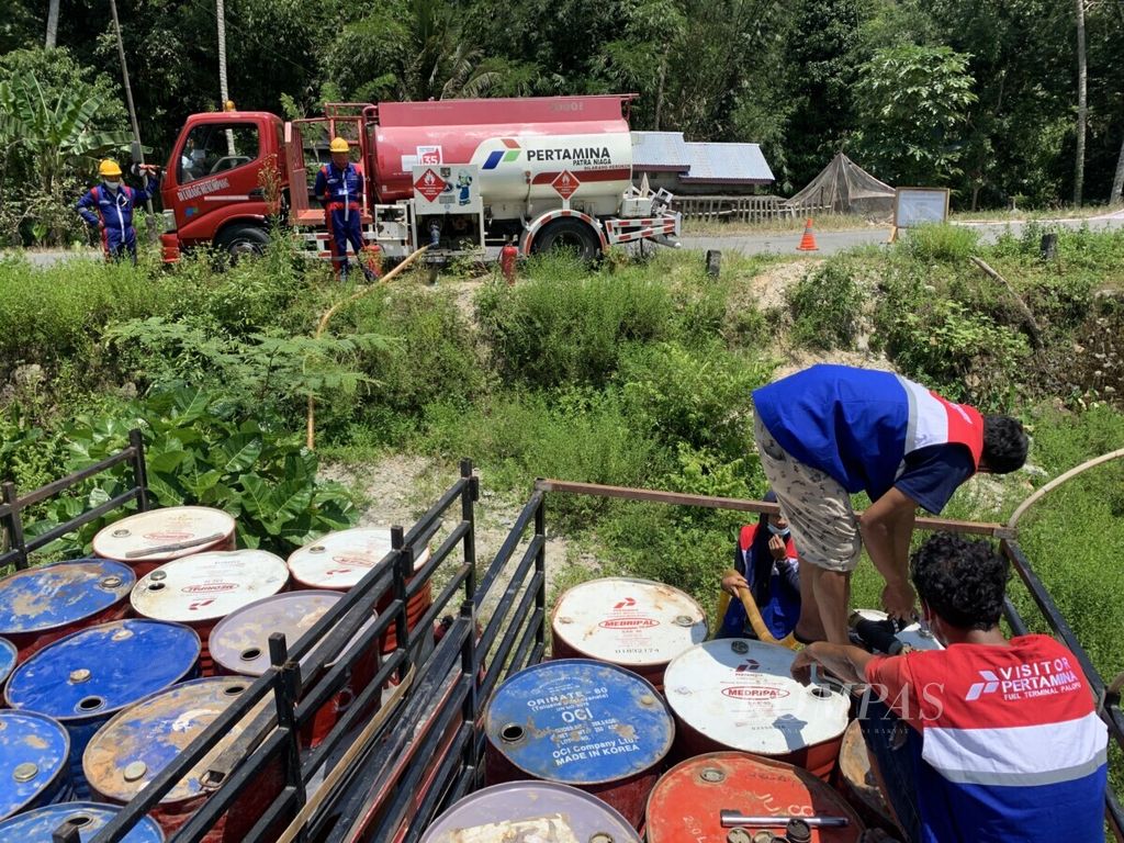 Petugas Pertamina mengisi bahan bakar ke drum dari tangki di Desa Tandung, Kecamatan Sabbang, Kabupaten Luwu Utara, Sulawesi Selatan, Minggu (25/10/2021).