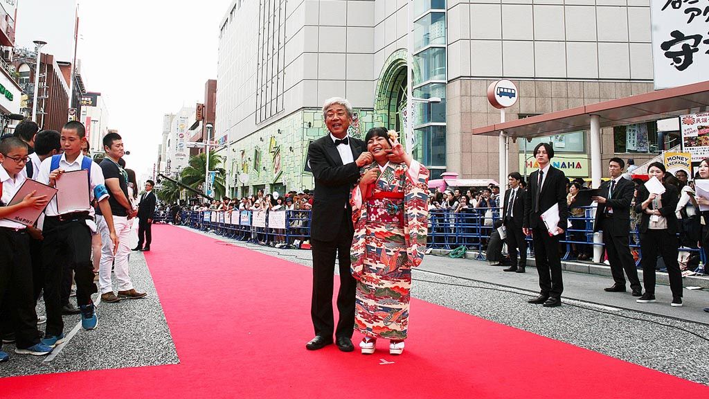 CEO Yoshimoto Kogyo Hiroshi Osaki (kiri) di atas karpet merah pada Okinawa International Movie Festival di Okinawa, Minggu (23/4). 