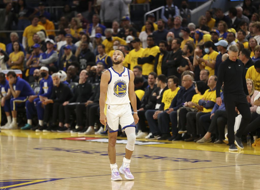 Pemain Golden State Warriors, Stephen Curry, memandang papan skor pada kuarter keempat laga pertama Final Bola Basket NBA di Chase Center, San Francisco, Jumat (3/6/2022) pagi WIB.