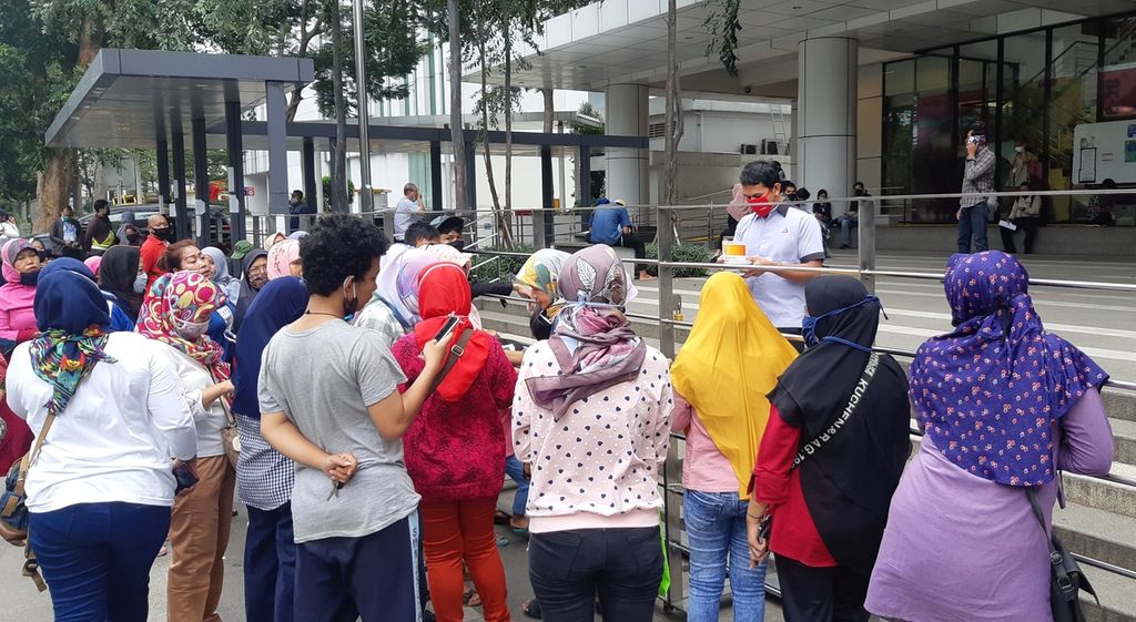 Para orangtua penerima KJP menunggu namanya dipanggil oleh karyawan Bank DKI yang membagikan buku rekening di Mal Pelayanan Publik DKI Jakarta, Selasa (16/6/2020).