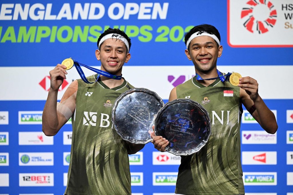 Indonesian players Fajar Alfian and Muhammad Rian Ardianto showed off the trophy and medals they won after becoming champions of All England at Utilita Arena, Birmingham, England on Sunday (17/3/2024).