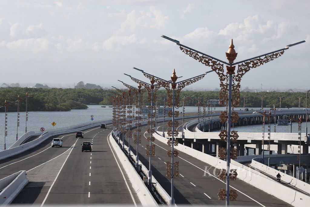 Kendaraan melintasi Tol Bali Mandara di Denpasar, Bali, Selasa (5/7/2022). Tol sepanjang 12,7 kilometer itu terus dipercantik untuk menyambut pelaksanaan G20 di Bali pada bulan November tahun ini. Tol tersebut dipercantik, antara lain, dengan penambahan panel surya, tiang lampu penerangan jalan, dan penanaman bibit mangrove.