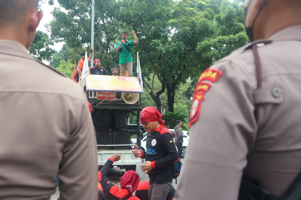 Buruh berorasi dalam aksi unjuk rasa di depan Balai Kota Jakarta, Jumat (2/11/2022). Aksi pada hari ini dihadiri lebih kurang 100 buruh yang tergabung dari berbagai organisasi buruh dan serikat pekerja. Aksi akan diadakan hingga 7 Desember 2022.