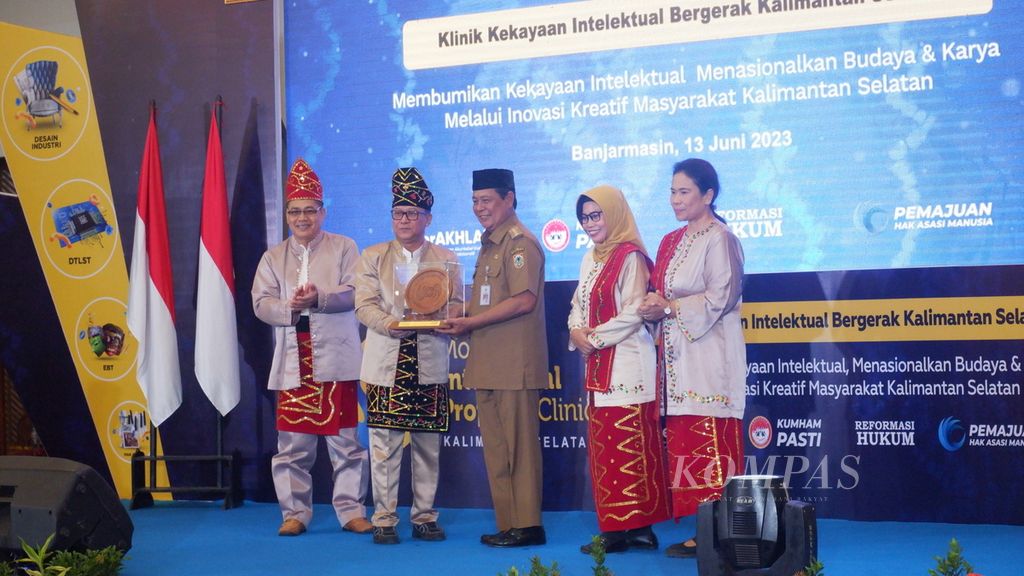 Staf Ahli Menteri Hukum dan Hak Asasi Manusia Bidang Ekonomi Lucky Agung Binarto (kedua dari kiri) menyerahkan cendera mata kepada Gubernur Kalimantan Selatan Sahbirin Noor di Banjarmasin, Selasa (13/6/2023).