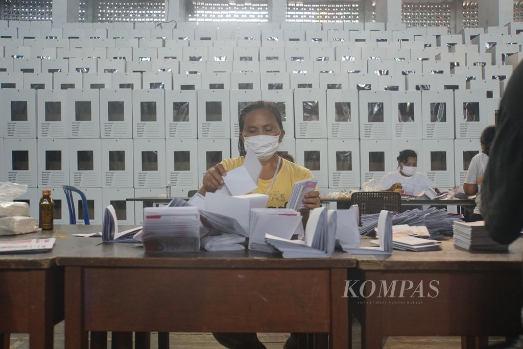 Pekerja harian lepas melipat surat suara pemilihan wali kota Manado, Senin (23/11/2020), di arena bela diri Gelanggang Olahraga Robert Wolter Mongisidi, Sario, Manado, Sulawesi Utara. 