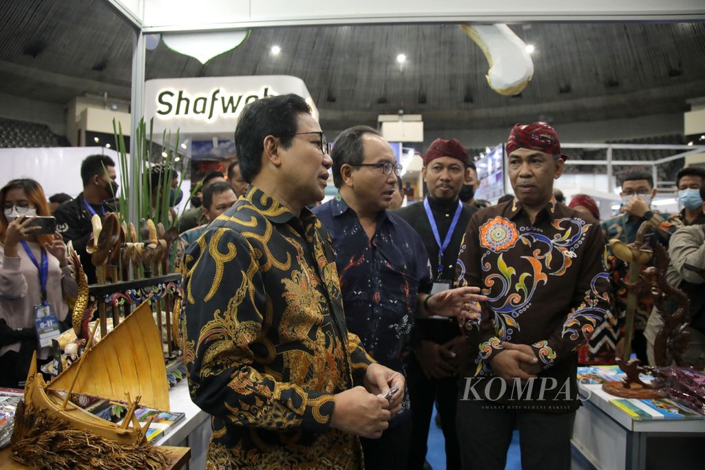 Minister of Villages, Development of Disadvantaged Regions and Transmigration Abdul Halim Iskandar accompanied by Deputy General Leader of Kompas Daily Budiman Tanuredjo looks at the exhibition booth at the 2022 Kompas Travel Fair at the Jakarta Convention Center Senayan, Jakarta, on Friday (9/9/2022).