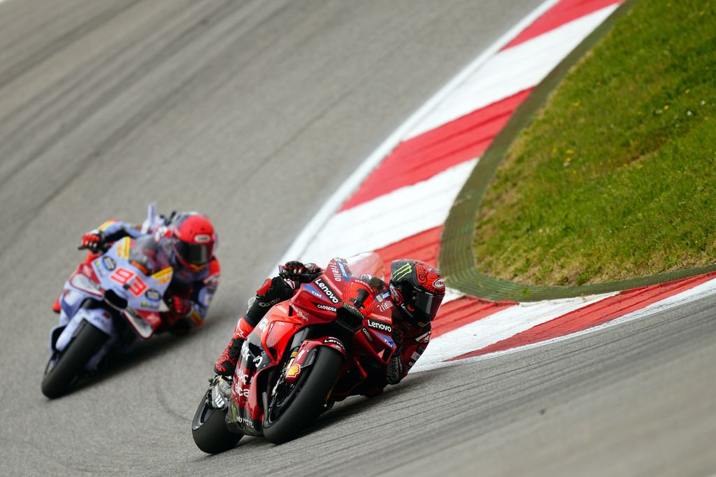 Ducati Lenovo rider, Francesco Bagnaia, was driving his motorcycle around a turn followed by Ducati Gresini Racing rider, Marc Marquez, during the MotoGP Grand Prix Portugal race at the Algarve International Circuit in Portimao, Portugal, on Sunday (24/3/2024).
