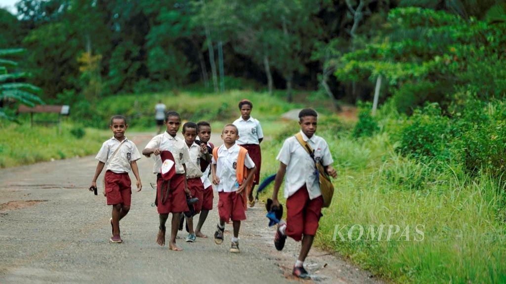 Murid SDN Mawan berlarian sepulang sekolah di Distrik Mandobo, Boven Digoel, Papua, Selasa (3/3/2020). 