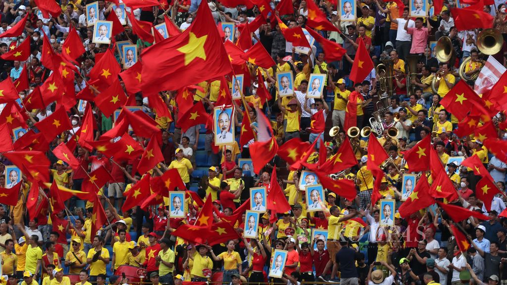 Ratusan warga bernyanyi dan membawa sejumlah poster bergambar tokoh Ho Chi Minh di Stadion Thien Truong, Nam Dinh, Vietnam, untuk menyaksikan laga pertandingan sepak bola yang bertepatan dengan perayaan hari kelahiran tokoh tersebut, Kamis (19/5/2022). Ho Chi Minh merupakan tokoh negarawan besar yang berjasa besar bagi warga Vietnam sekaligus Presiden republik demokratik Vietnam yang pertama. Ho Chi Minh lahir pada 19 Mei 1890 di kota Saigon yang kini dikenal dengan nama Ho Chi Minh City. 