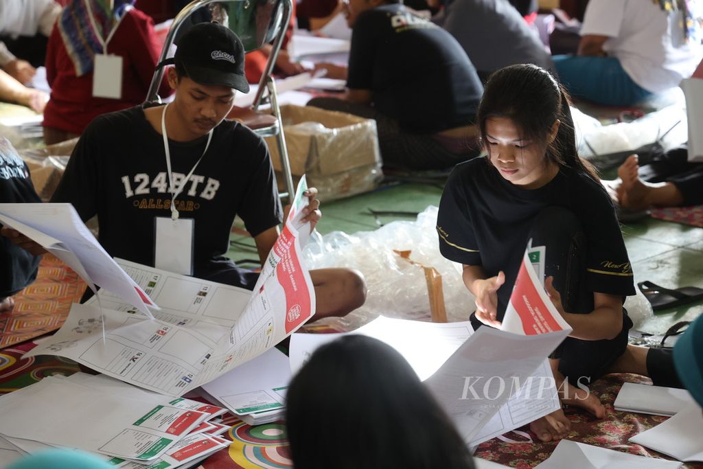 Warga bekerja sebagai tenaga penyortir dan pelipat surat suara pemilu di Balai Desa Deyangan, Mertoyudan, Magelang, Jawa Tengah, Jumat (12/1/2024). 