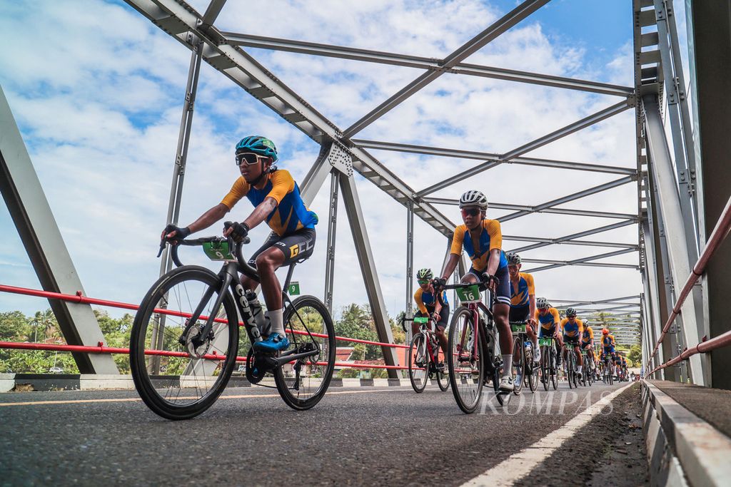 Para pebalap melintasi jembatan Cipandak, Cidaun, Cianjur, Jawa Barat, pada etape pertama Cycling de Jabar 2023, Sabtu (8/7/2023).  