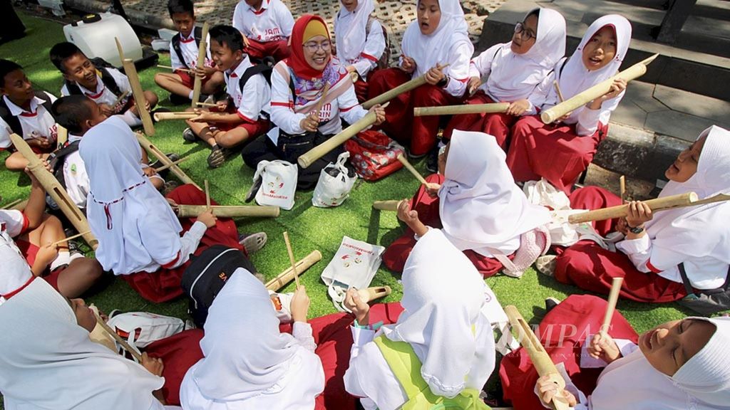 Siswa SD Negeri 185 Cihaurgeulis, Kota Bandung, bermain kentungan di halaman Gedung Sate, Bandung, Jawa Barat, Selasa (24/9/2023). 