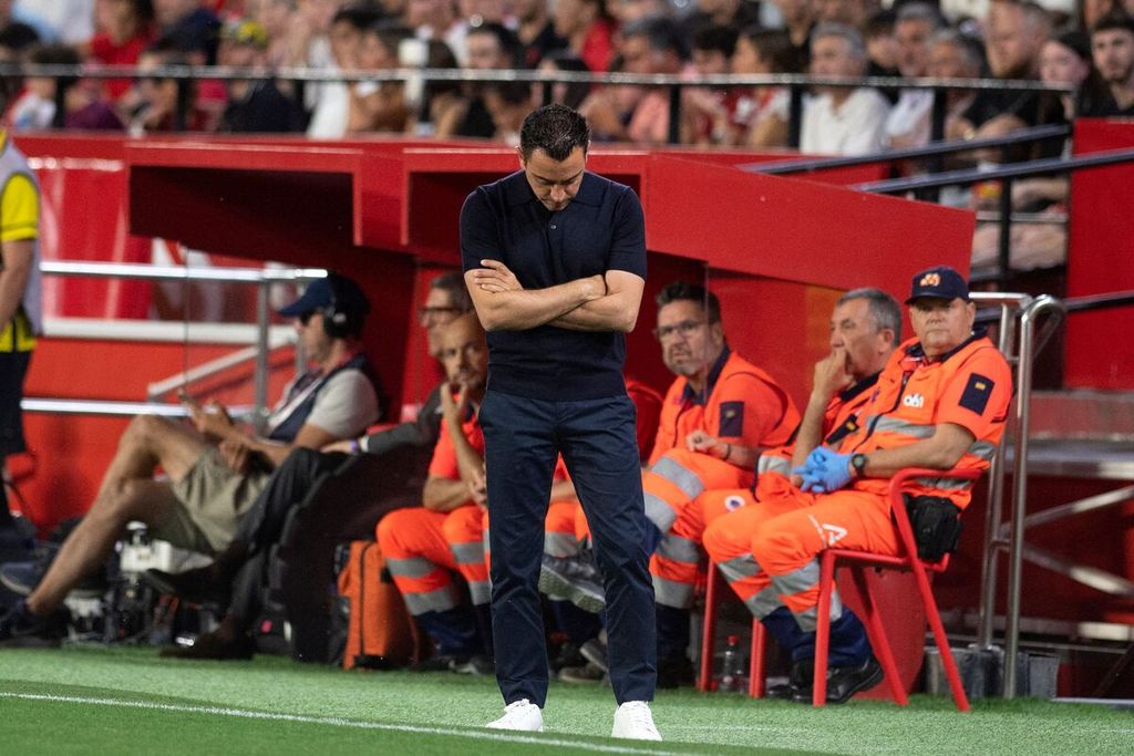Barcelona coach Xavi Hernandez looks down during the Spanish League match between Sevilla and Barcelona at Ramon Sanchez Pizjuan Stadium, Sevilla, early Monday morning (27/5/2024) Western Indonesian Time. The match was Xavi's last game as Barcelona's coach.