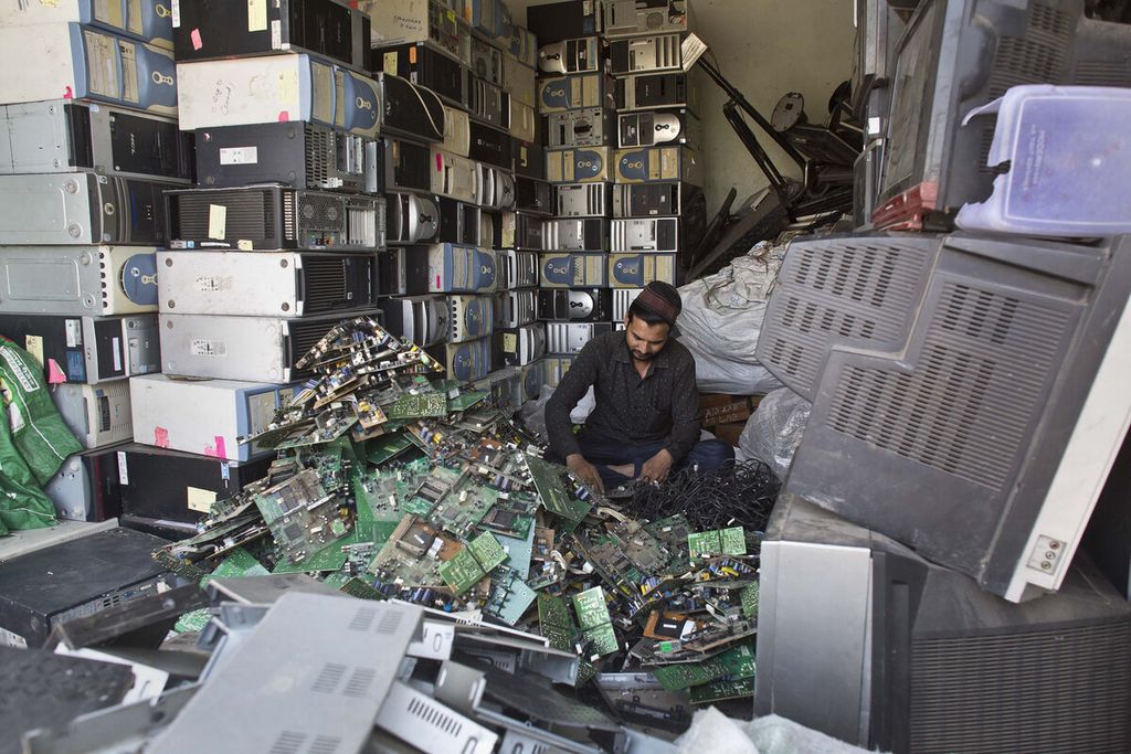 Seorang laki-laki India bekerja di toko daur ulang sampah elektronik di Gauhati, Negara Bagian Assam, India, pada 5 Juni 2017.