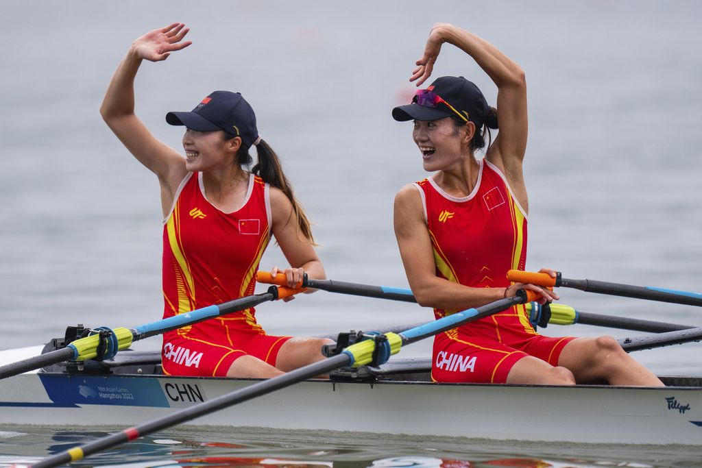 Pedayung China, Zou Jiaqi (kiri) dan Qiu Xiuping, merayakan kemenangan mereka pada nomor rowing lightweight double sculls putri pada Asian Games Hangzhou 2022, pada Minggu (24/9/2023) di Fuyang Water Sports Centre.
