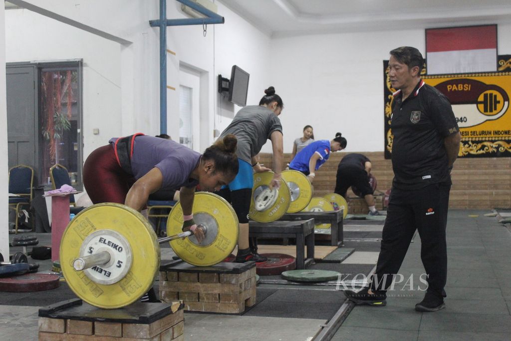Pelatih tim angkat besi Indonesia, Dirdja, sedang berbincang dengan lifter putri asal Papua, Natasya, di sela-sela latihan pada Rabu (26/4/2023). Natasya bakal disiapkan untuk mengikuti Kejuaraan Asia di Jeju, Korea Selatan.