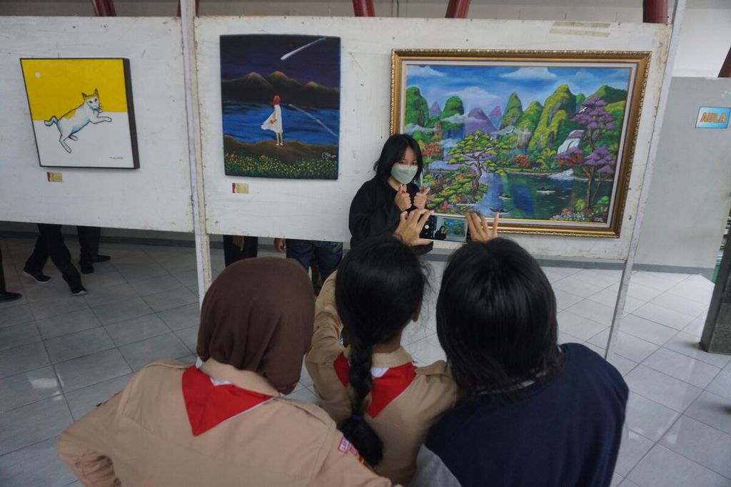 Para pelajar SMPN 1 Purwokerto berfoto di depan lukisan yang dipajang di Taman Edukasi Sumber Daya Air Purwokerto, Banyumas, Jawa Tengah, Jumat (26/8/2022).