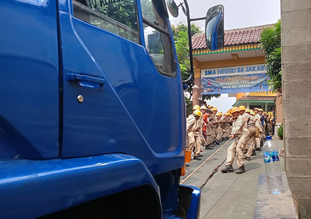 Petugas PT KAI dan petugas gabungan bersama warga gotong royong menarik truk barang yang menabrak tiang listrik aliran atas (LAA) di jalur rel listrik di Km 17+5 antara Stasiun Pondok Ranji dan Kebayoran, Jalan Bintaro Permai IV, Pesanggrahan, Jakarta Selatan, Selasa (25/7/2023).