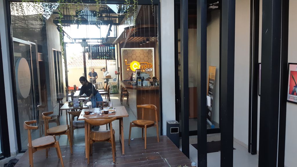 A worker cleans tables at Crypto Cafe in Kuta District, Badung Regency, Bali Province. As of April 2023, the cafe is accepting payments with crypto assets for purchases of food and drinks.