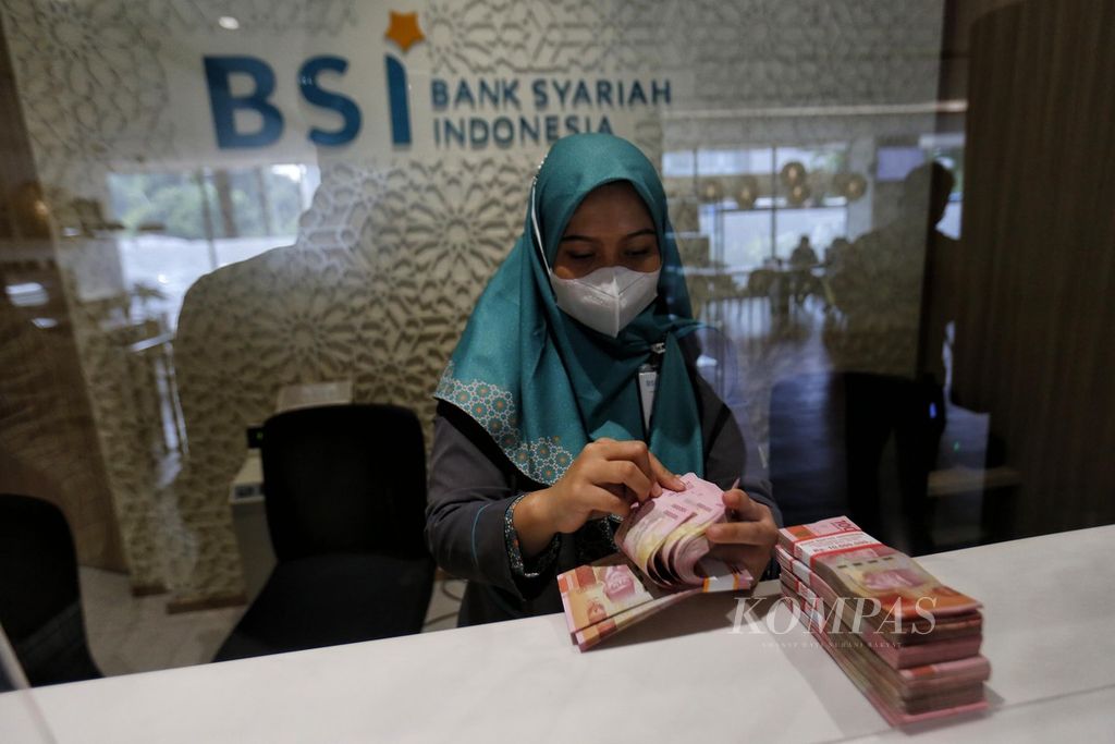 Petugas Bank Syariah Indonesia menghitung uang kertas rupiah di kantor cabang BSI Thamrin, Jakarta, Senin (22/5/2023). Berdasarkan kurs referensi Jakarta Interbank Spot Dollar Rate (Jisdor) kemarin, nilai tukar rupiah menguat 39 poin menjadi Rp14.897 per dollar AS. 