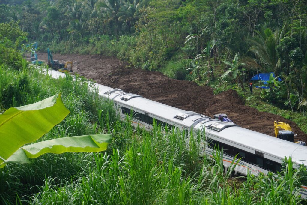 Sebuah kereta dari arah barat menuju Purwokerto melintasi rel jalur hilir yang sudah dibersihkan dari material longsoran di Desa Gununglurah, Kecamatan Cilongok, Kabupaten Banyumas, Jawa Tengah, Selasa (5/12/2023).