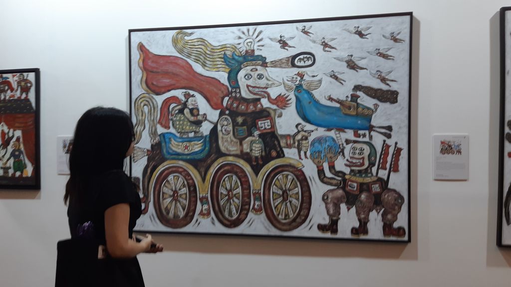 Lukisan berjudul <i>Semar and the Angel's Perspectrive of the World</i> (2018) karya Heri Dono ditampilkan untuk Art Moments Jakarta, Minggu (11/8/2024). Karya ini menunjukkan keterhubungan antara yang tradisi lewat figur Semar dan yang modern lewat sosok malaikat dalam Art Moments Jakarta yang berlangsung 9-11 Agustus 2024 di Ballroom Hotel Sheraton, Gandaria City, Jakarta.