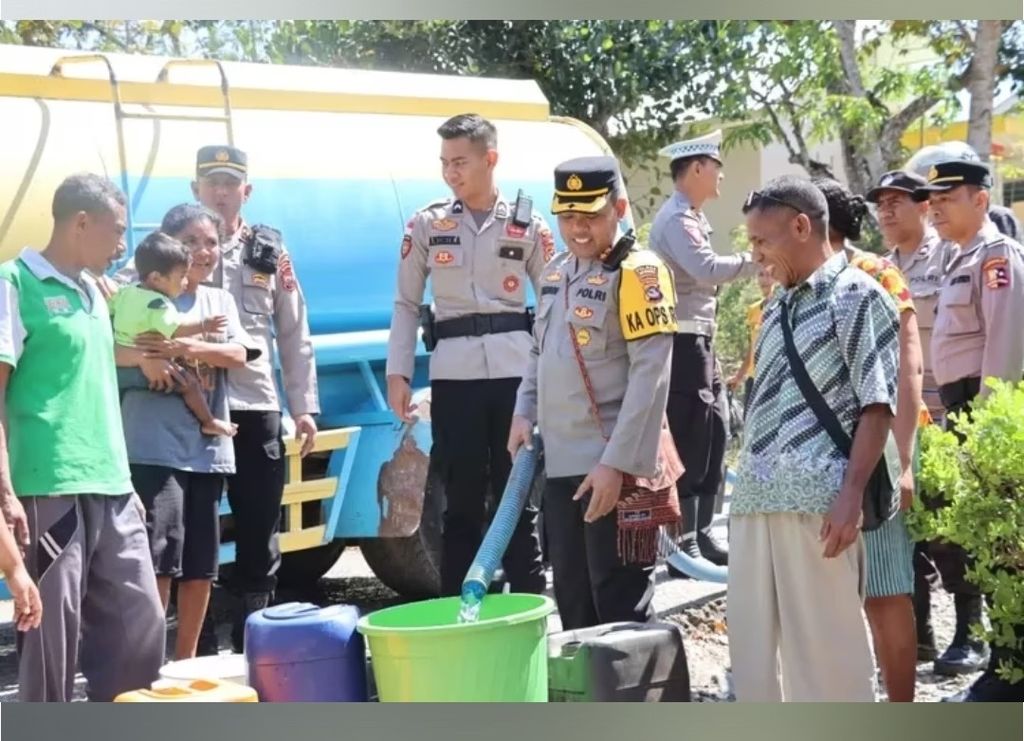 Petugas Polres Timor Tengah Utara dipimpin Kapolres TTU Ajun Komisaris Besar Moh Mukhson menuangkan air dari mobil tangki ke dalam ember milik warga, Rabu (30/8/2023).