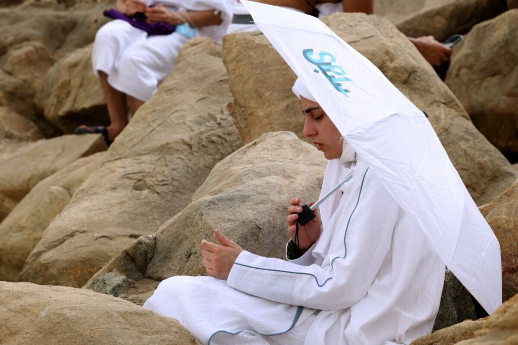 Muslim pilgrims gather around Mount Arafat, also known as Jabal al-Rahma (Mount of Mercy), southeast of the holy city of Mecca, during the climax of the Hajj pilgrimage amid the COVID-19 pandemic, on July 19, 2021.  Muslim pilgrims gathered at Mount Arafat today in the high point of this year’s hajj, being held in downsized form and under coronavirus restrictions for the second year running. Just 60,000 people, all citizens or residents of Saudi Arabia, have been selected to take part in this year’s hajj, with foreign pilgrims again barred. 