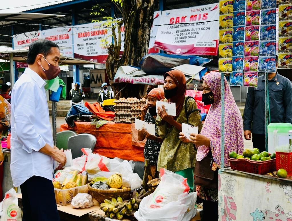 Presiden Joko Widodo saat memberikan bantuan sosial di Pasar Bangkal Baru, Kabupaten Sumenep, Jawa Timur, Rabu (20/4/2022).