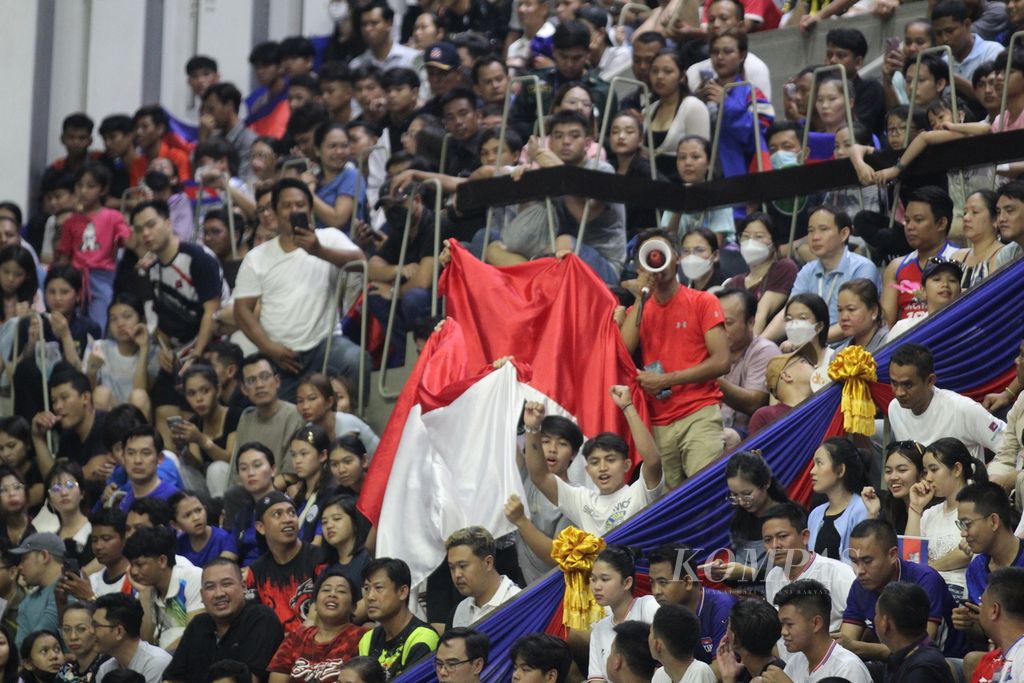 Pendukung Indonesia tetap memberi dukungan di tengah ribuan pendukung tuan rumah pada laga penentu juara grup A bola voli putra SEA Games Kamboja 2023 di Phnom Penh, Kamboja, Sabtu (6/5/2023). 