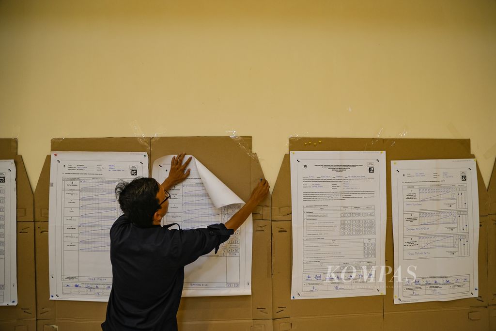 Petugas PPK menempelkan hasil penghitungan suara di TPS menjelang dimulainya rekapitulasi hasil penghitungan suara tingkat kecamatan di GOR Pengadegan, Kecamatan Pancoran, Jakarta Selatan, Jumat (16/2/2024). 