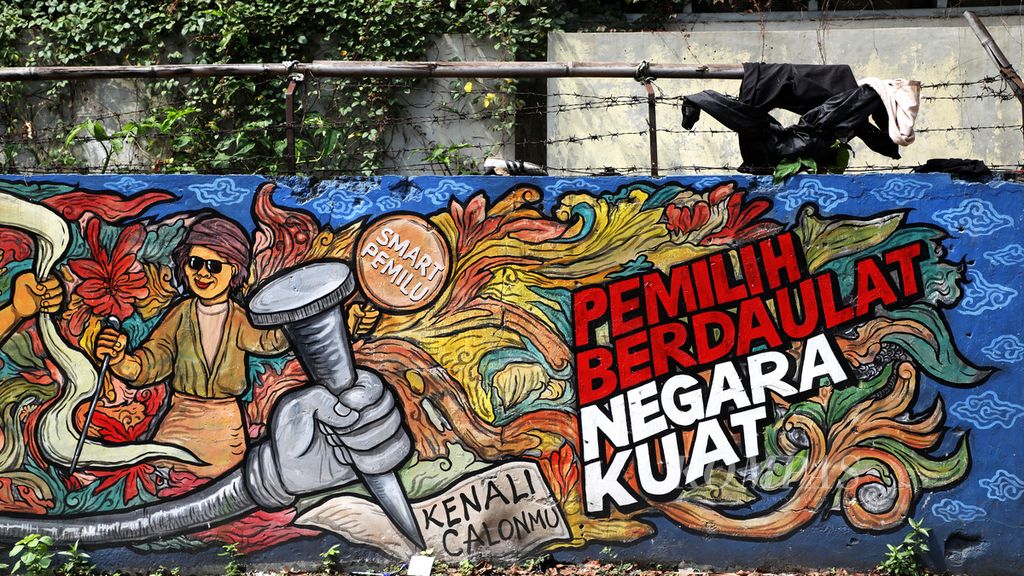 Mural tentang pemilihan umum yang diinisiasi Komisi Pemilihan Umum di pagar tembok di Jalan Kebon Jahe, Kota Tangerang, Rabu (25/3/2020). 