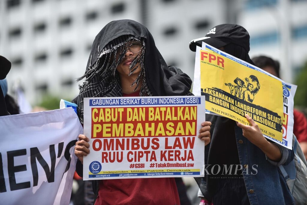 Para buruh dan mahasiswa memperingati Hari Perempuan Internasional dengan berunjuk rasa di depan Gedung DPR, Senayan, Jakarta, Senin (9/3/2020).