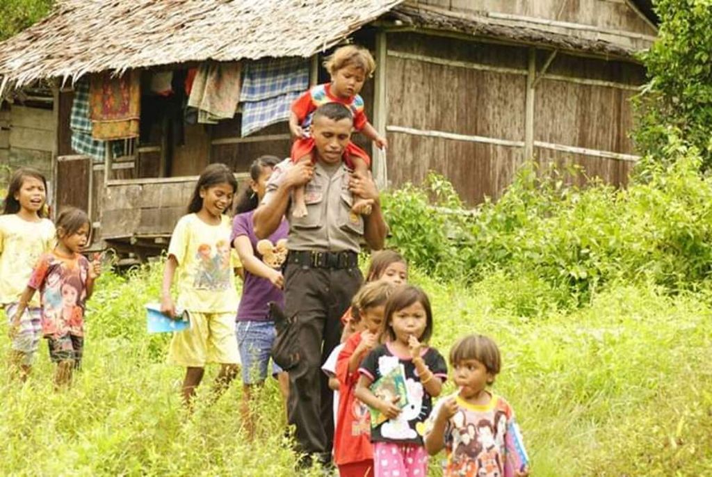 Brigadir Kepala Bastian Tuhuteru bersama anak-anak di Dusun Walapau, Desa Wamlama, Kecamatan Namrole, Kabupaten Buru Selatan, Maluku. Anggota Polri itu mengajar anak-anak di kampung yang belum tersentuh akses pendidikan.