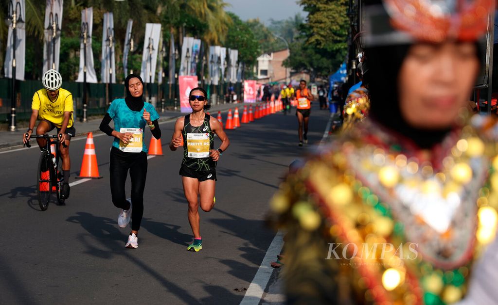 Yulianti Utari (kiri) dan Pretty Sihite, pelari Elite Race kategori putri yang bersaing ketat pada ajang Borobudur Marathon 2022 Powered by Bank Jateng di kawasan Candi Borobudur, Jawa Tengah, Sabtu (12/11/2022). Penyelenggaraan Borobudur Marathon 2022 tersebut dilaksanakan selama dua hari pada 12-13 November yang terbagi dalam tiga kategori, yaitu Bank Jateng Young Talent, Elite Race, dan Tilik Candi. Pada penyelenggaraan lomba lari maraton tersebut juga diberikan kesempatan bagi para atlet muda untuk merintis prestasi mereka. 