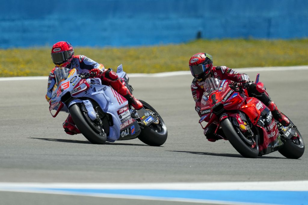 Gresini Racing rider Marc Marquez (left) drives his motorcycle followed by Ducati Lenovo rider Francesco Bagnaia during the main race of the MotoGP Grand Prix Series in Spain at Jerez-Angel Nieto Circuit in Jerez de la Frontera on Sunday (28/4/2024).