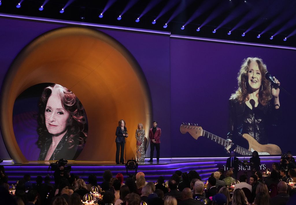 Musisi Bonnie Raitt (kiri) menerima penghargaan Song of the Year untuk lagu ”Just Like That” di malam penganugerahan ke-65 Grammy Awards di Los Angeles, AS, Minggu (5/2/2023) malam waktu setempat. 