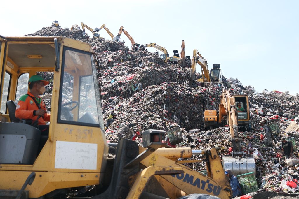Petugas sedang mengoperasikan sejumlah traktor dan eksavator merapikan setiap sampah yang datang dibawa truk sampah dari segala penjuru Jakarta pada Selasa (26/04/2022).