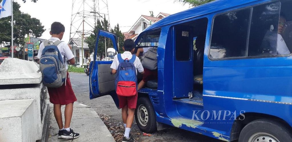 Sejumlah siswa sekolah dasar pulang ke rumah dengan menggunakan angkutan umum di Kabupaten Temanggung, Jawa Tengah, beberapa waktu lalu.